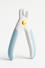 LED pet nail clipper with LED light illuminated on a white background